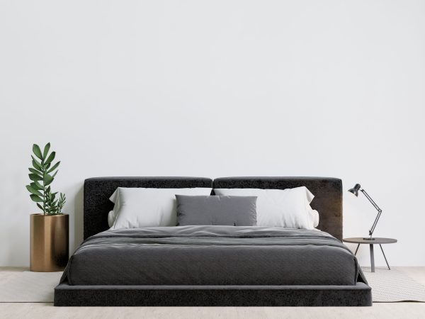 Made by elix Contemporary bedroom with a luxurious bed, decorative plants, and a table lamp.